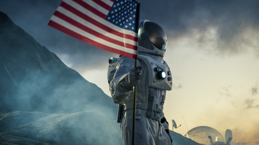 astronaut with American flag on moon