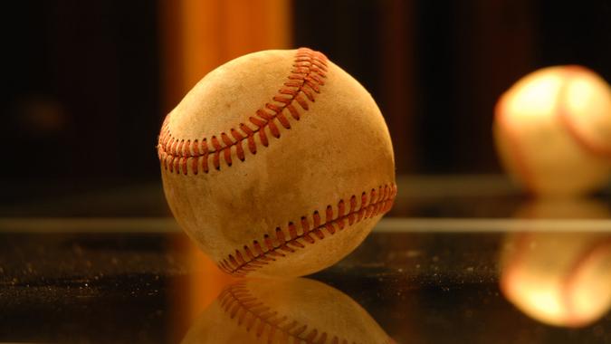 Baseball inside a glass trophy case.