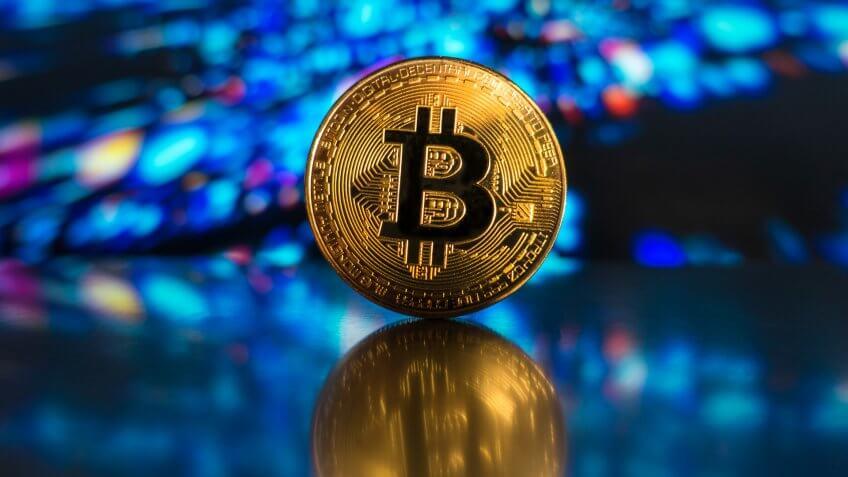 izmir, Turkey - November 20, 2017 Studio shot of golden Bitcoin with a digital background.