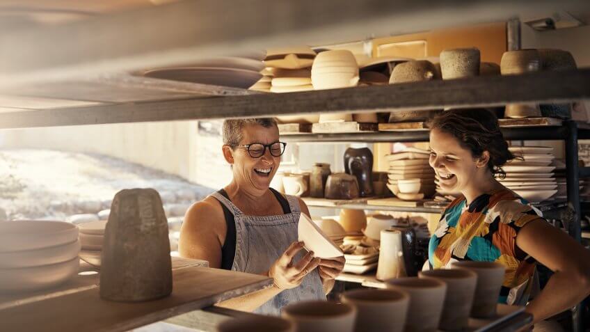 Shot of a potter talking to her coworker