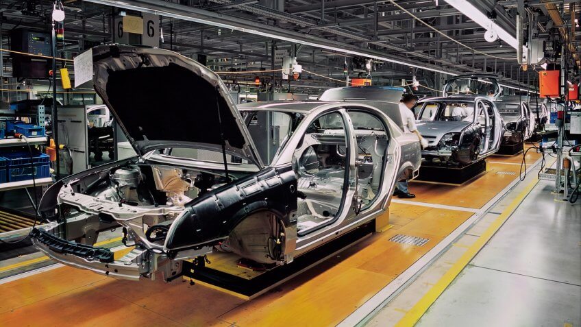 car production line with unfinished cars in a row.