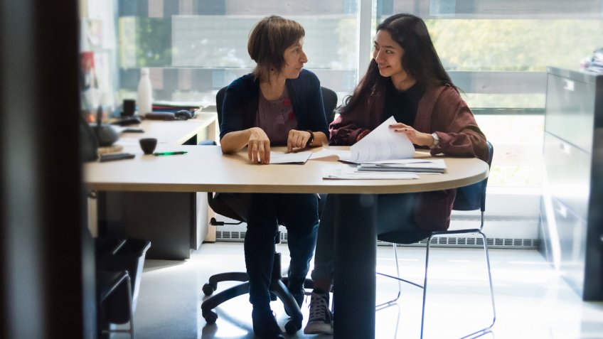 Counselling appointment for young asian woman student in counsellor College office.