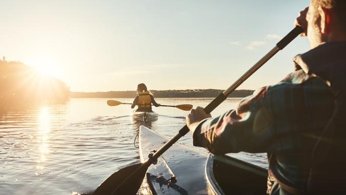 Our favourite lake to kayak on Shot of a young couple kayaking on a lake outdoors.