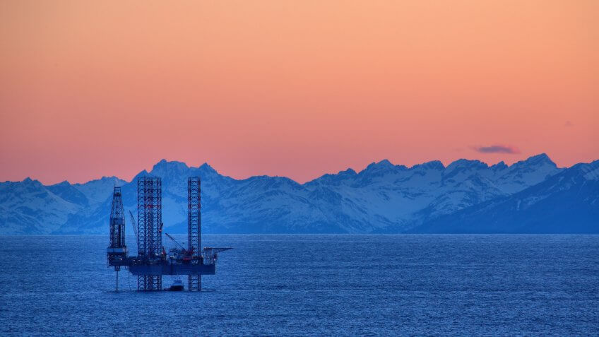 Sun sets on the Cook Inlet and this drilling rig.