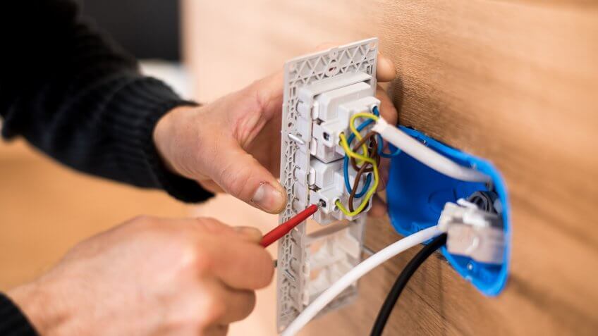 Close-up photo of installing an electrical outlet.