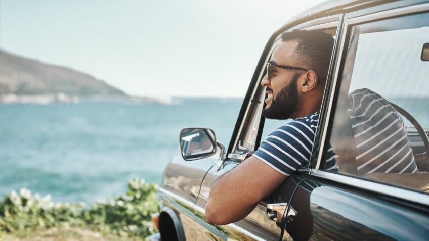 Shot of a young man enjoying a road trip.