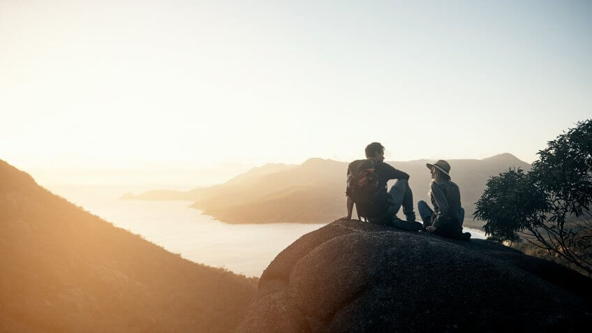 Shot of a young couple hiking the mountains in the morning.