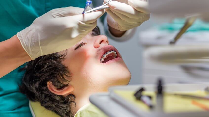 kid getting braces in orthodontist office