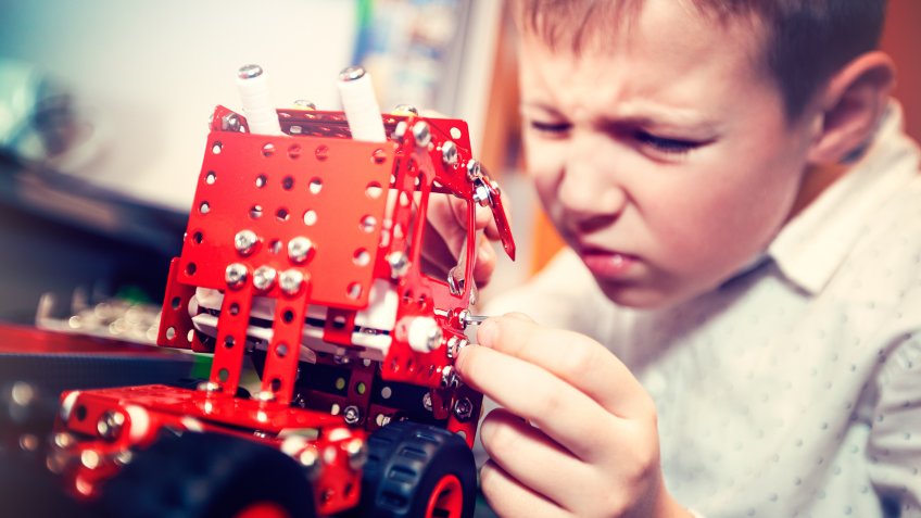 Boy turns a toy car.