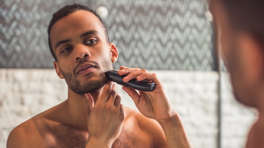 man using electric razor