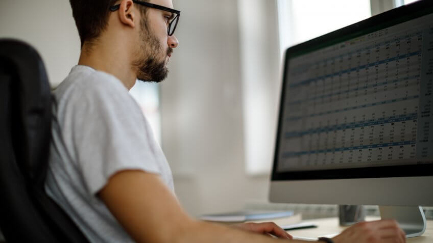 Young man working in his office.