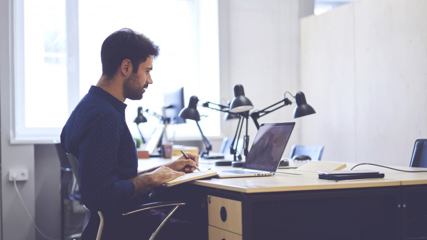 man working on laptop for business
