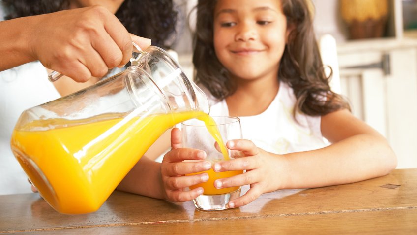 mom pouring orange juice