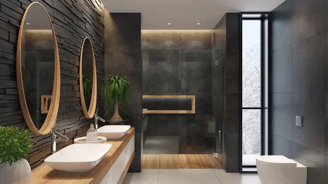 contemporary minimalist bathroom with two round mirrors and wooden frame.