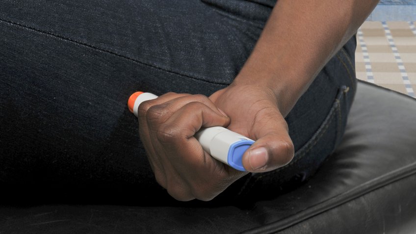 person using EpiPen