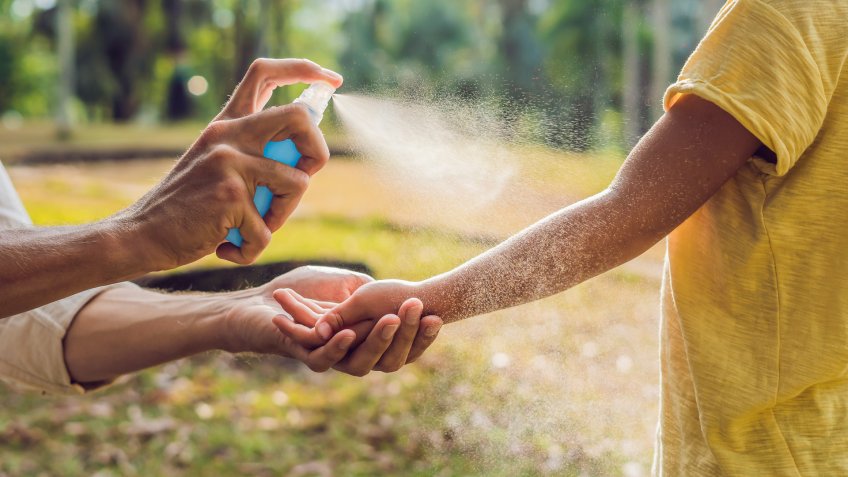 putting on bug spray