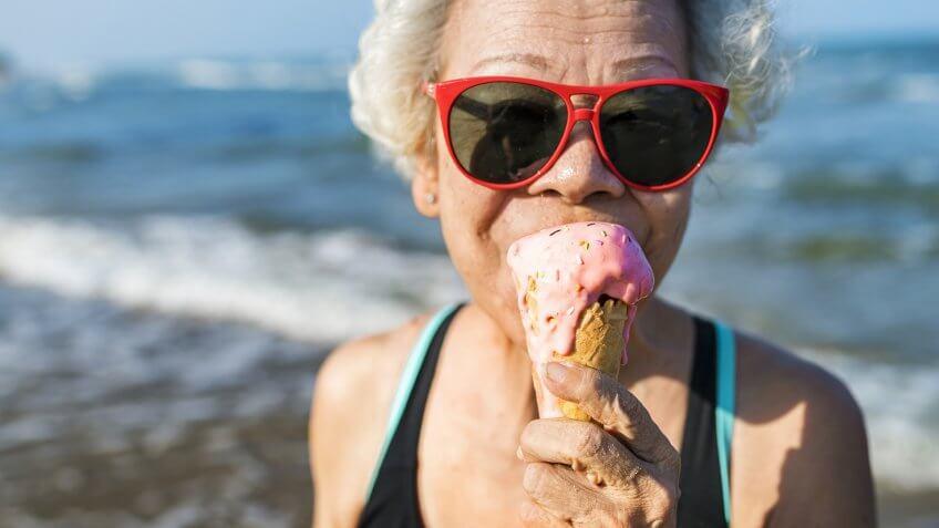 Senior woman eating an ice-cream.