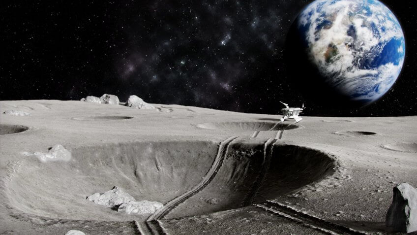 Traces of the moon rover through a crater on the Moon, the planet earth in the background, 3D render.
