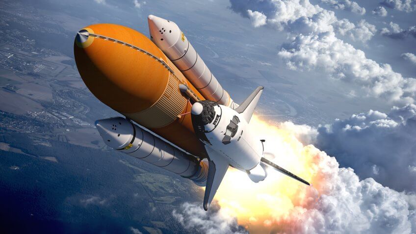 Space Shuttle Flying Over The Clouds.