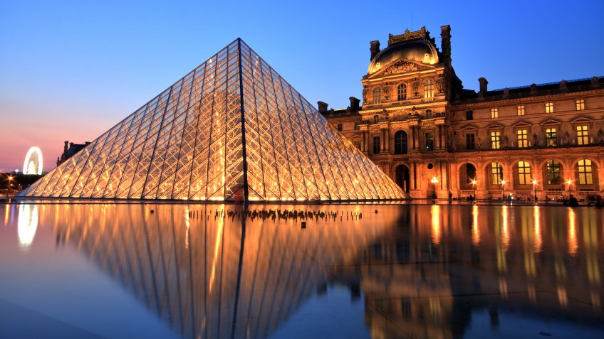 Paris, France - July 6, 2013: Illuminated Louvre museum during sunset in Paris.