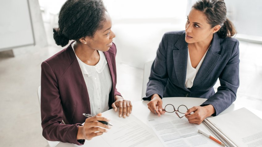 Two women discussing new contract.