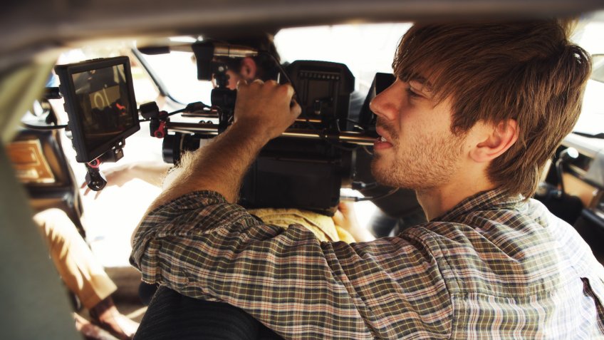 Camera operator shooting handheld.