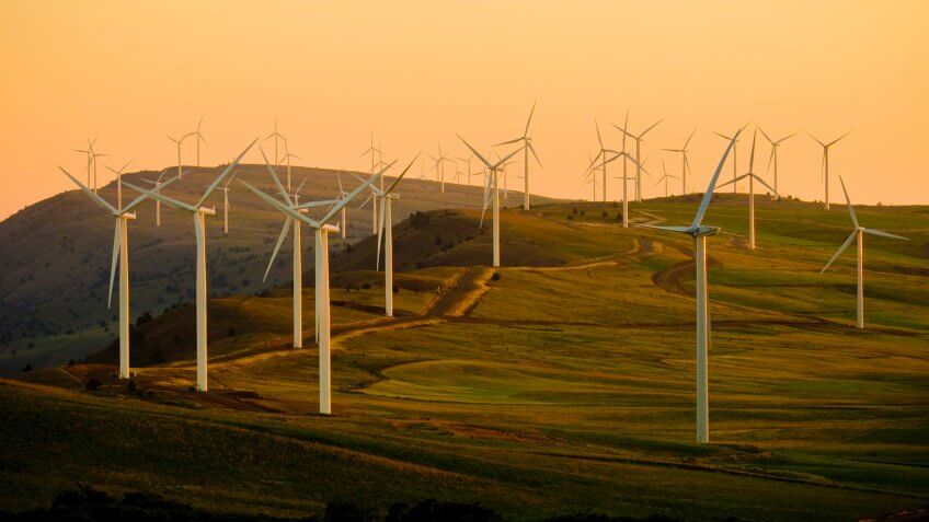windmills on green field under white sky during daytime