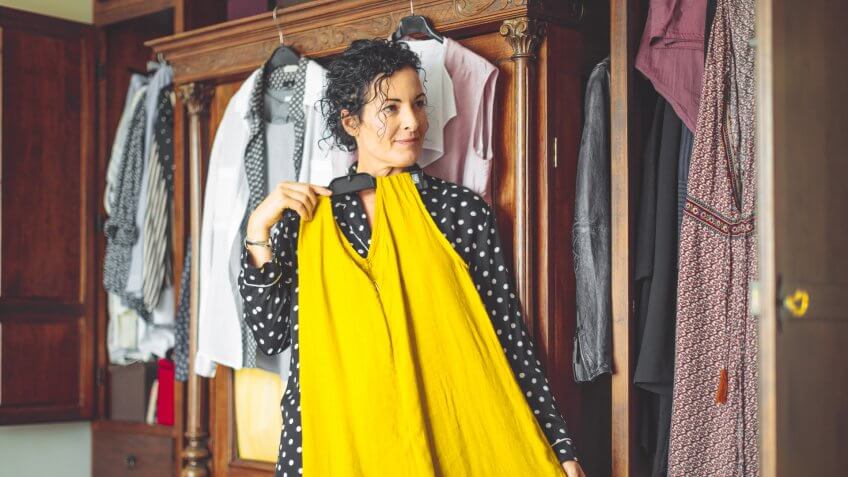 Woman is choosing the right dress to wear.