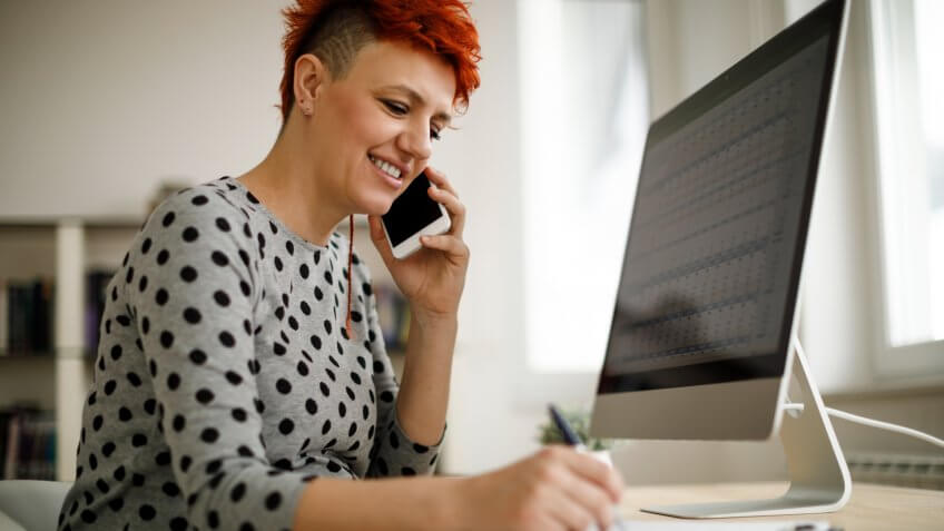 Pregnant woman working from home office.