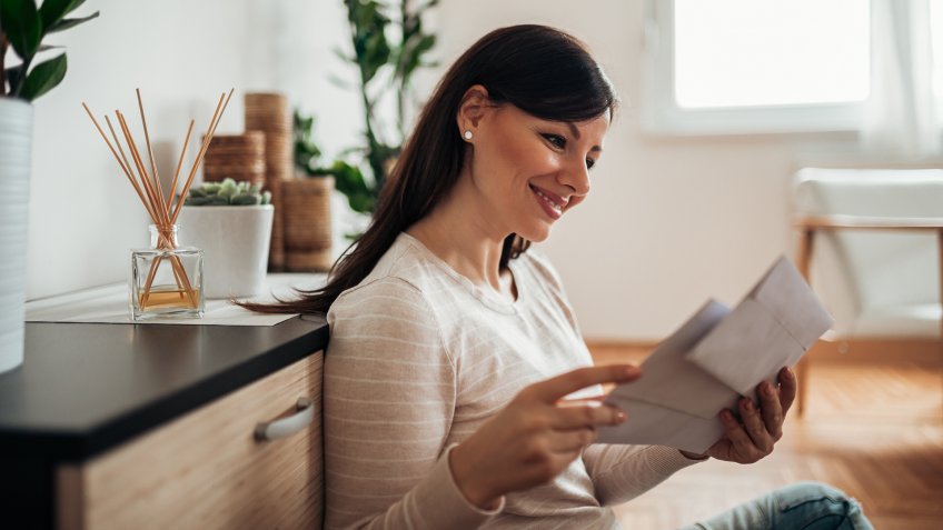 Charming woman receiving a letter.