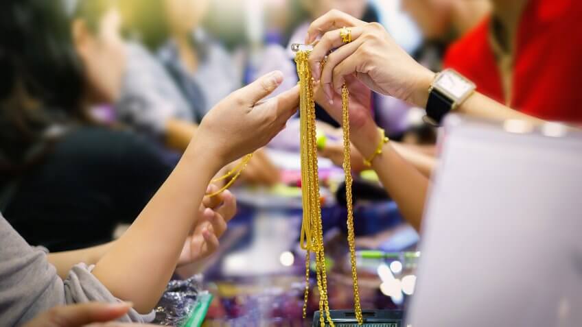 Customers are buying gold jewelry in the gold shop.