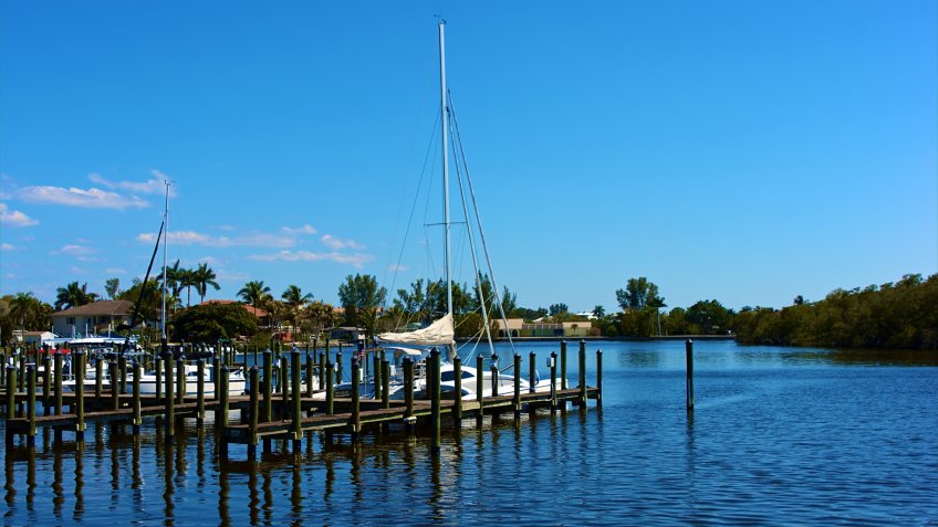 scenic view of boats at dock in canal in bonita springs, florida - Image.