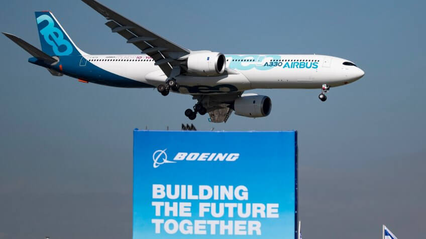 Airbus A330 Neo flies over Boeing sign at 53rd International Paris Air Show