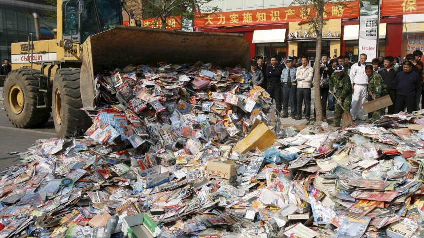 Chinese law enforcement destroy pirated DVDs