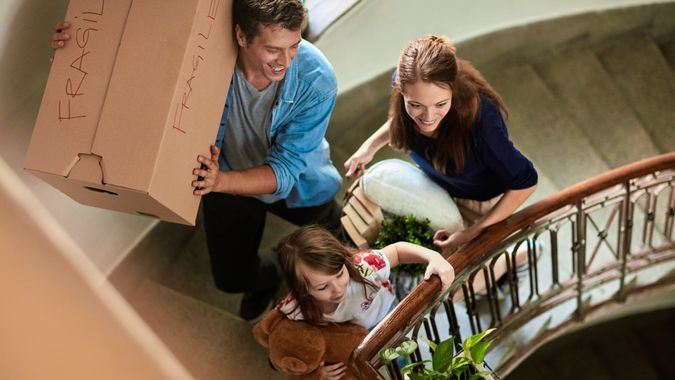 Close up of a young family moving home.