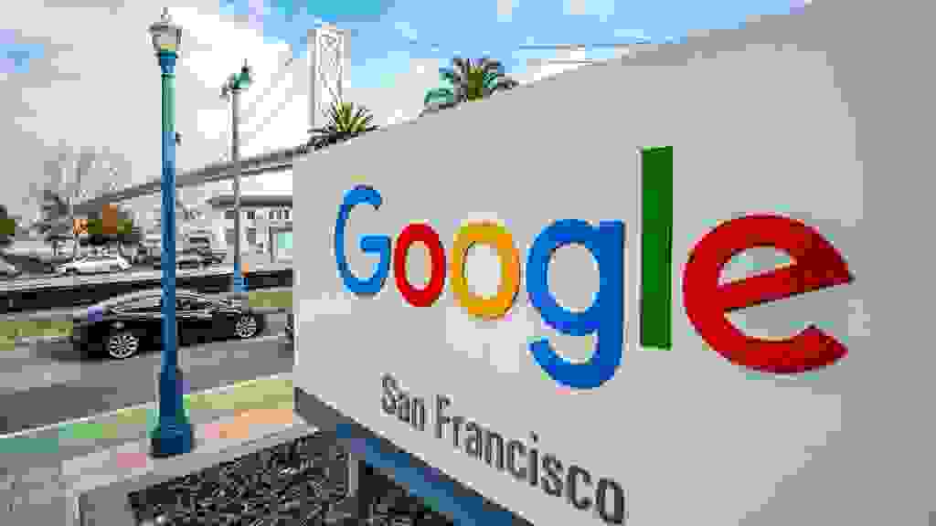 San Francisco, USA - A large sign outside Google's offices in San Francisco, with the San Francisco - Oakland Bay Bridge in the background.