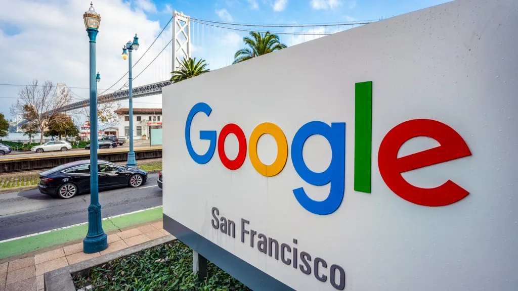 San Francisco, USA - A large sign outside Google's offices in San Francisco, with the San Francisco - Oakland Bay Bridge in the background.