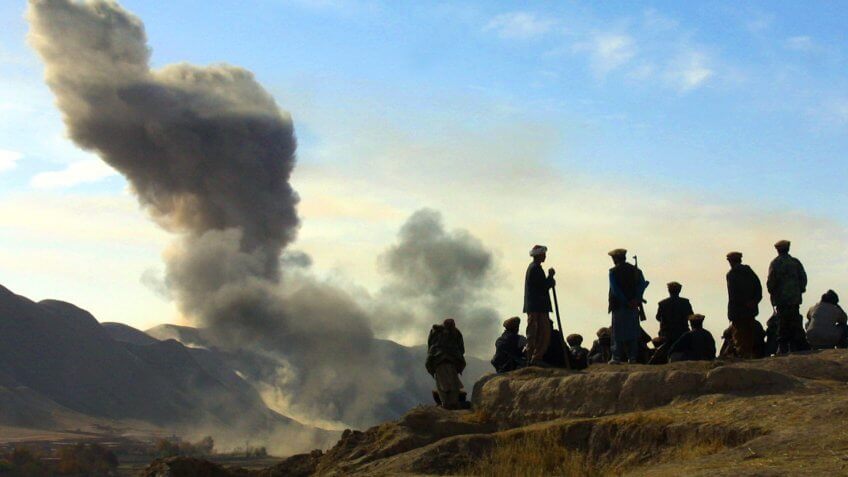 Northern Alliance soldiers watch as US air strikes pound Taliban in Afghanistan