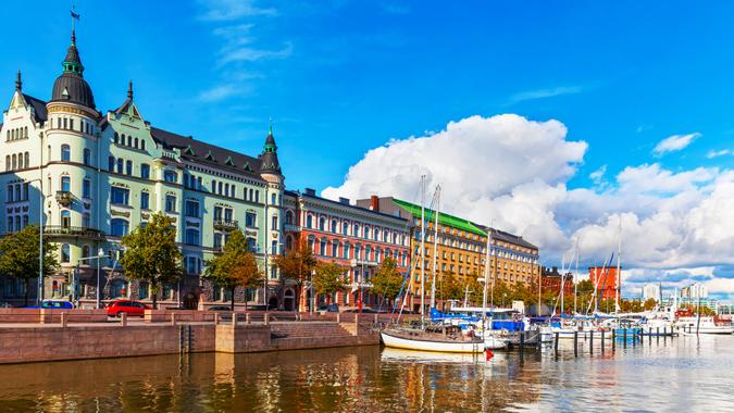 Scenic summer view of the Old Port pier architecture with ships, yachts and other boats in the Old Town of Helsinki, Finland.