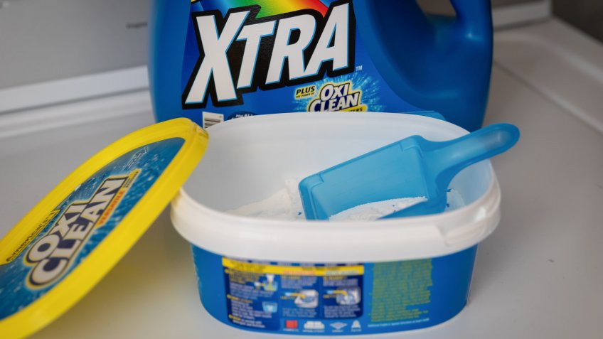 Coconut Creek, Florida USA - June 02, 2019: OxiClean Stain Remover powder and OxiClean Liquid Laundry Detergent behind laying on a machine in laundry room - Image.