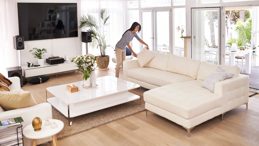 Shot of a young woman tidying her househttp://195.