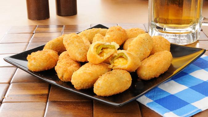 Jalapeno and cheddar cheese poppers with a mug of beer.