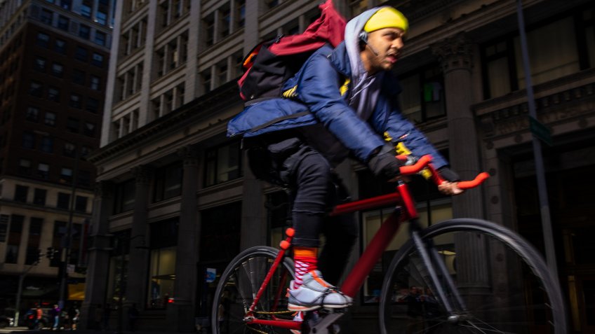 Dramatic portrait of a bike messenger or delivery person on the streets of Los Angeles, taken with a strobe.