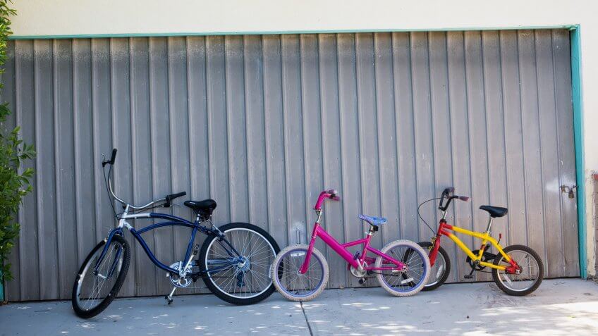 Bicycle, Childhood, Color Image, Day, Door, Driveway, Fun, Garage Door, Horizontal, Motion, Nobody, Outdoors, Photography, Speed, Three Objects, Togetherness, absence, leaning