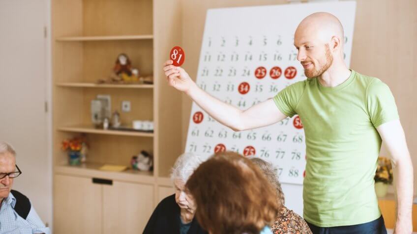 Seniors In The Nursing Home Playing Bingo For Relaxation.