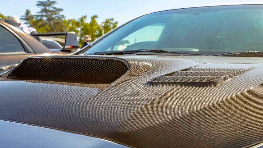 Carbon fiber hood of a silver car on a sunny day - Image.