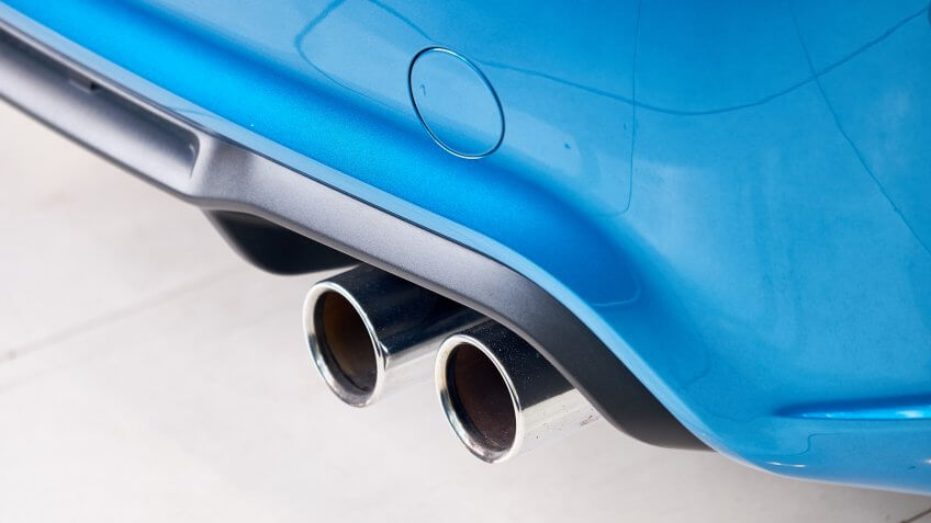 Close up of stainless steel exhaust tip muffler pipe cover of modern sports car.