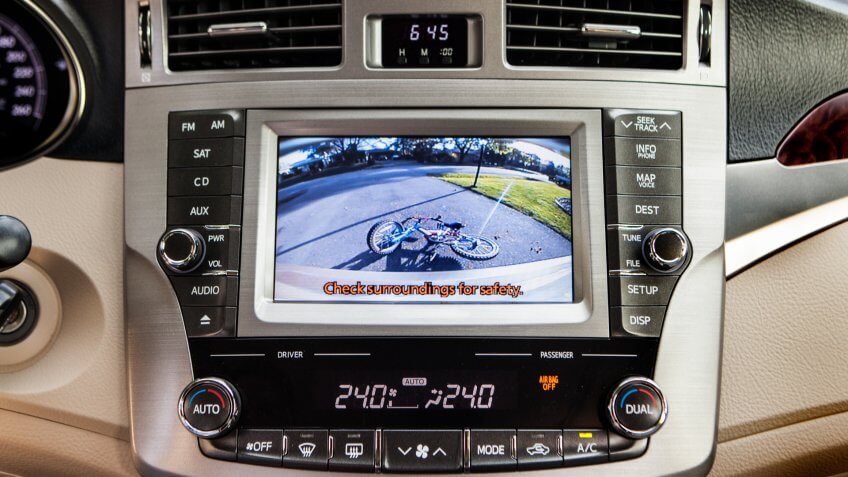 Automobile safety reverse camera screen on an interior dashboard.