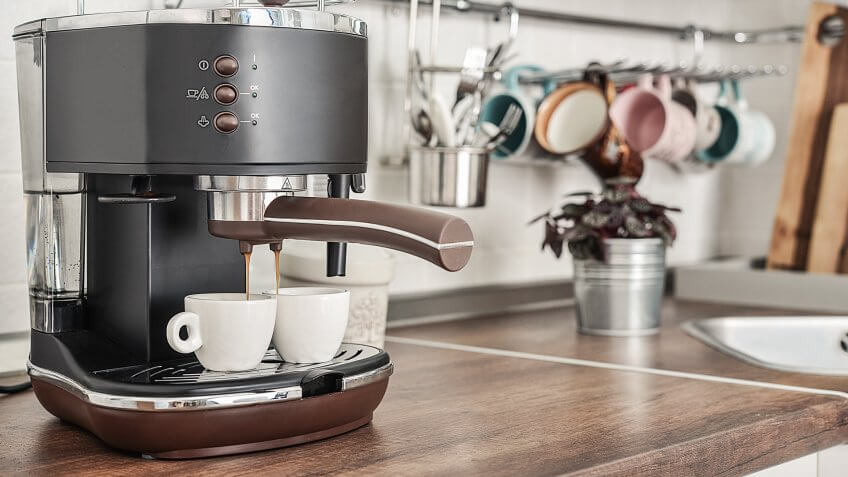 Coffeemaker with two cups in interior of modern kitchen closeup.