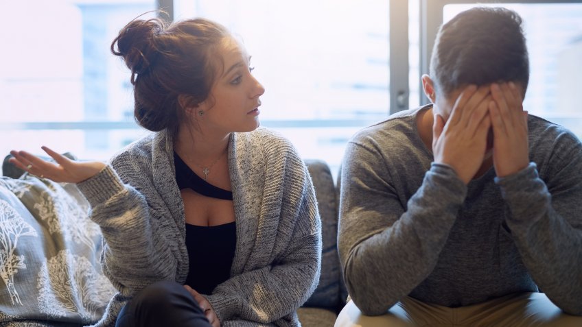 Shot of a young woman scolding her boyfriend in their home.